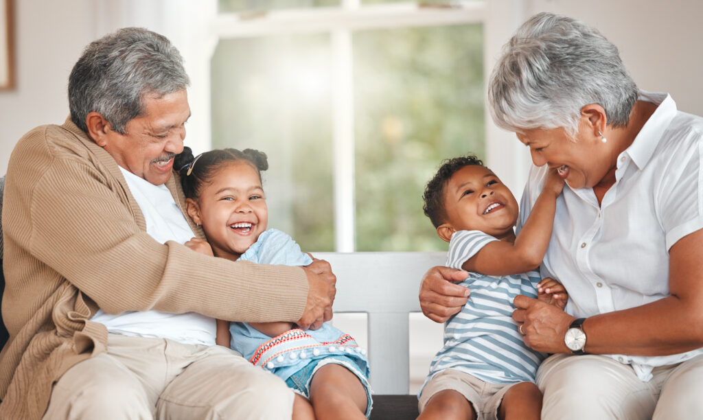 Shot of grandparents bonding with their grandchildren on a sofa at home.