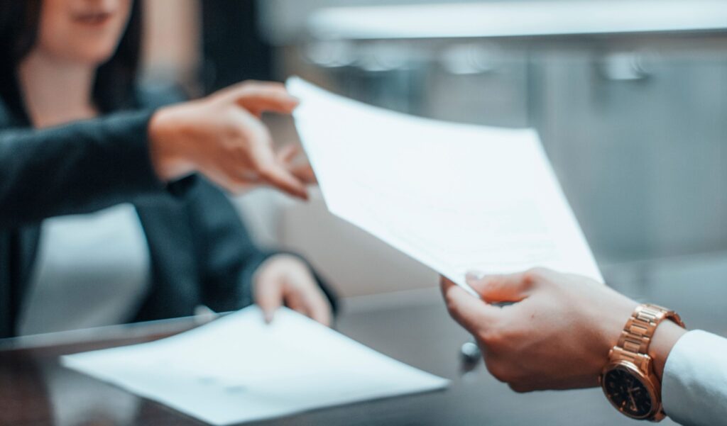 woman being handed forms