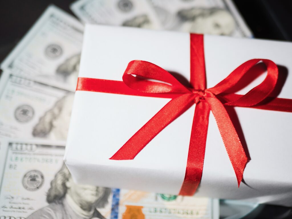 Gift box on top of money used for gift taxes.