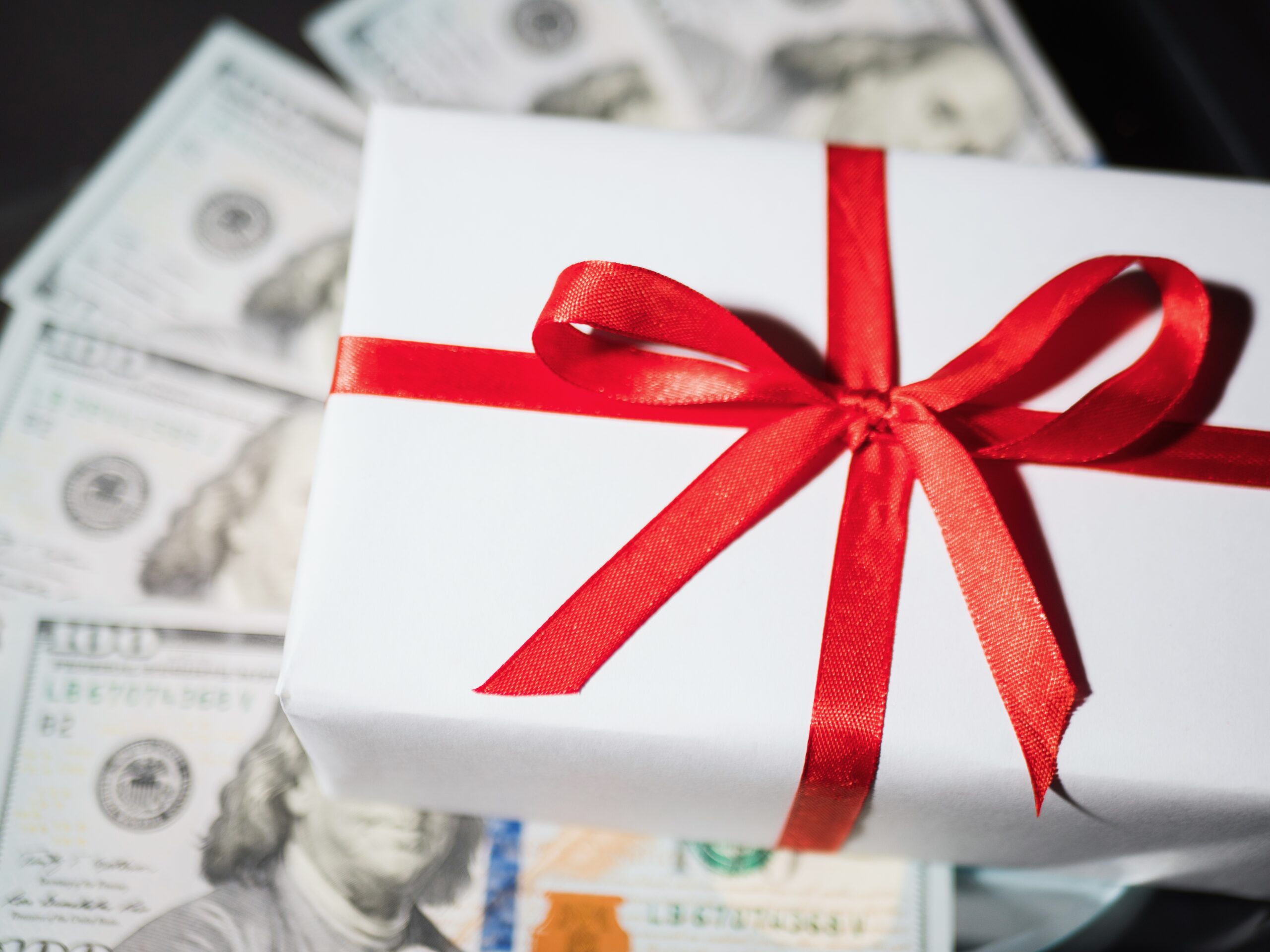 Gift box on top of money used for gift taxes.